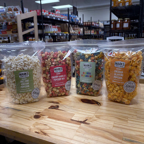Bags of Marks Trading Company gourmet popcorn, handcrafted in small batches in Adrian, Michigan